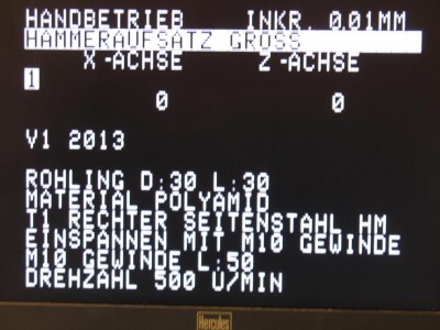 The screen in "HAND MODE" showing a header  (workpiece name) and comments imported from the CNC file.<br />The inverted 1 shows the CNC program bank (1 or 2).<br />I added this feature and meantime one can also use lower case letters (modified character EPROM ) and I changed also the layout of the first line.<br /><br />Originally the screen showed only the first line and the X / Z position, what a wasting of screen area. :-)