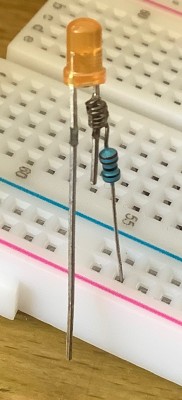 3mm LED with current limiting resistor soldered to one leg