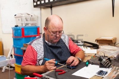 senior-man-working-with-soldering-iron-in-workshop.jpg